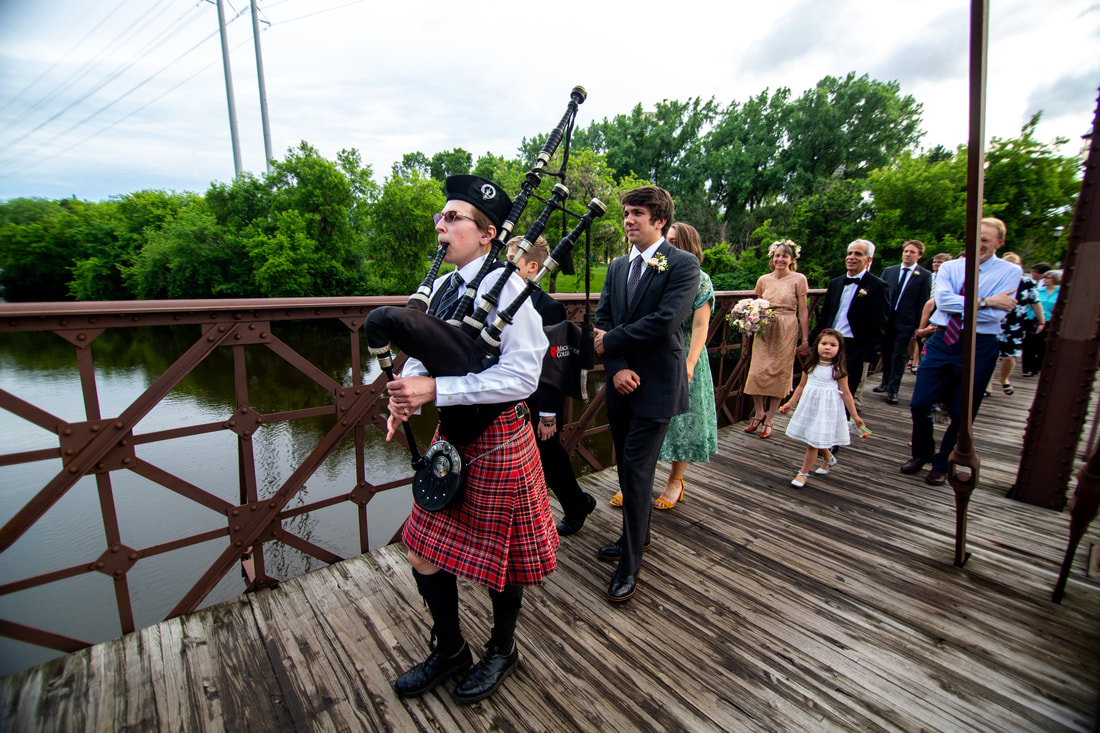 Bagpiper playing for wedding parade to reception venue