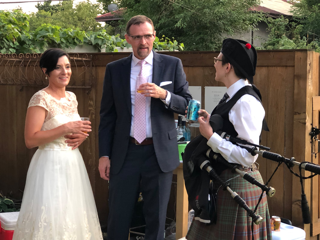Chatting with the bride and groom after surprise bagpipe performance at their wedding reception, Minneapolis, MN. 